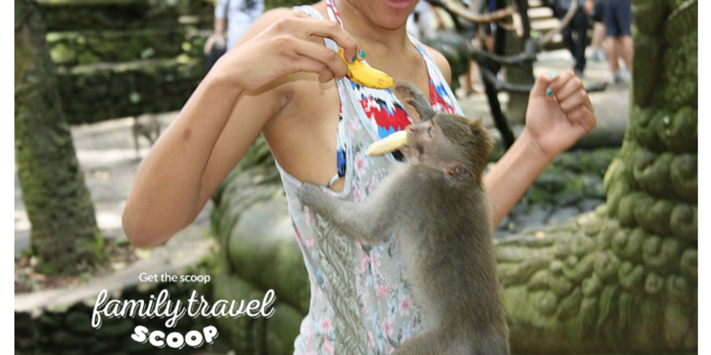 Girl feeding monkey in Bali