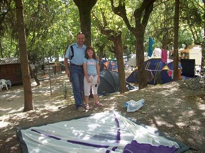 father and daughter putting up a tent in a campground