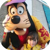 child with goofy at the Disney pool