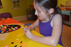 girl making lego