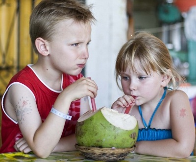 kids drinking a coconut