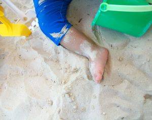 baby's leg on a beach