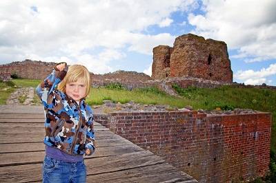 child in Denmark near ruin