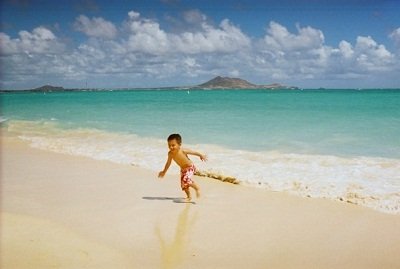 boy on the beach in Hawaiii