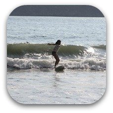 surfing child in costa rica