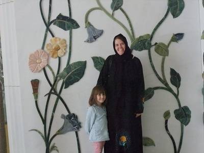 mother and daughter in front of mural at Grand Mosque Abu Dhabi