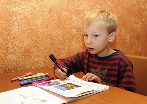 boy completing a travel journal