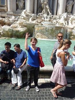 teen throwing a coin in the Trevi Fountain, Rome